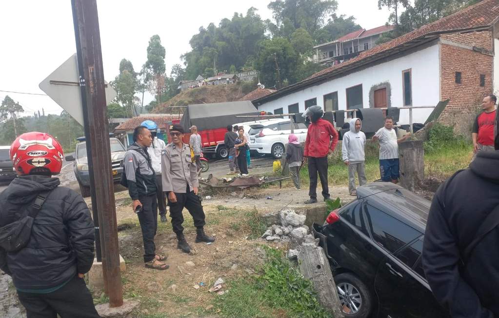 Kondisi mobil Toyota Kijang Innova yang ringsek di bagian depan setelah terperosok ke dalam parit di pinggir Jalan Raya Ciening, Cisurupan, Garut.